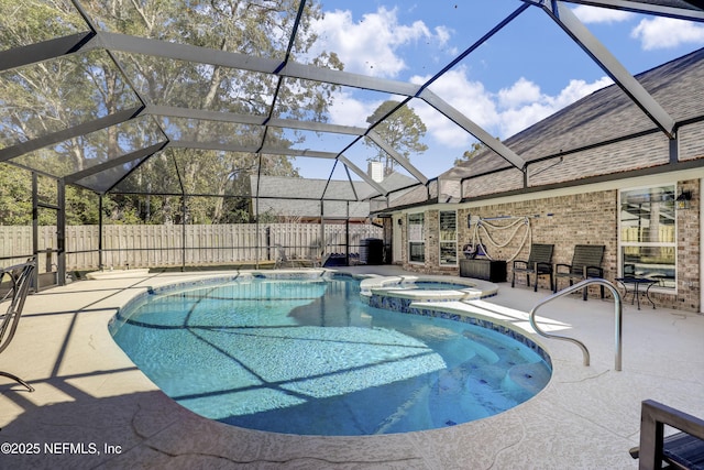 view of swimming pool featuring an in ground hot tub, a patio area, and glass enclosure