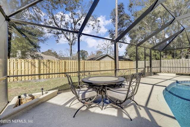 view of patio / terrace featuring glass enclosure and a fenced in pool