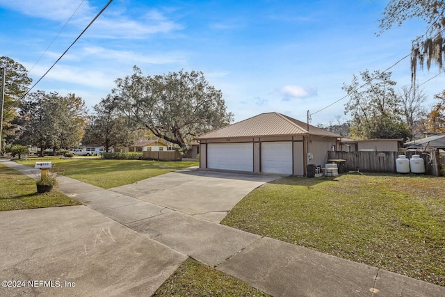 view of front of home featuring a garage and a front lawn