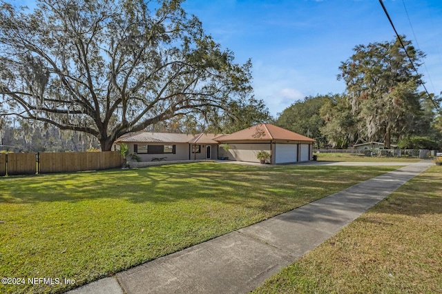 ranch-style house with a front yard and a garage