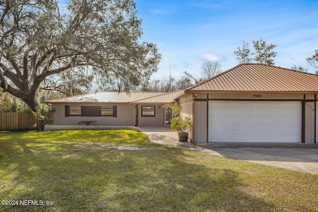 single story home featuring a front yard and a garage