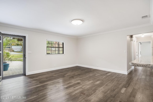 empty room featuring ornamental molding, dark wood-type flooring, and a healthy amount of sunlight