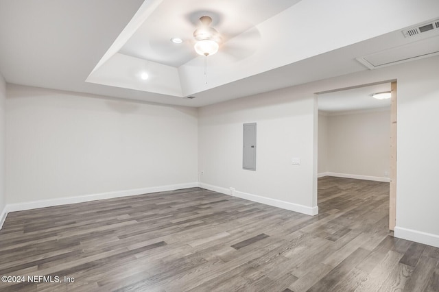 unfurnished room with electric panel, ceiling fan, and hardwood / wood-style flooring