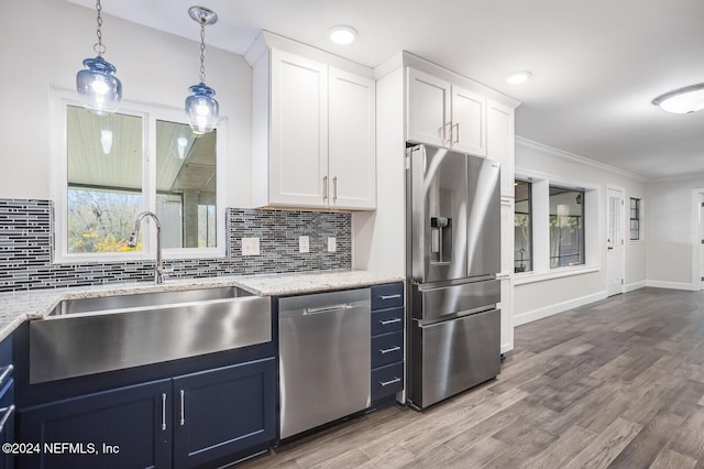 kitchen featuring hardwood / wood-style floors, white cabinets, sink, blue cabinetry, and appliances with stainless steel finishes