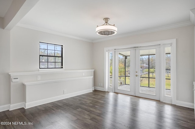 empty room featuring ornamental molding, dark wood-type flooring, and french doors