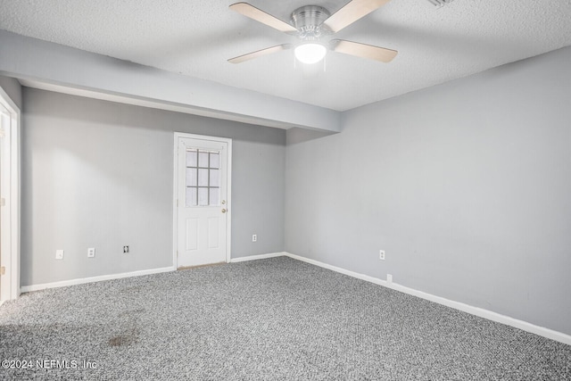 basement with carpet flooring, a textured ceiling, and ceiling fan