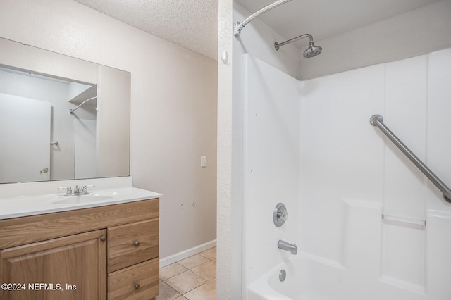 bathroom featuring tile patterned floors, vanity, washtub / shower combination, and a textured ceiling