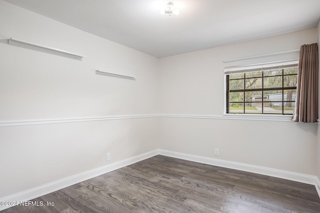 spare room with dark hardwood / wood-style floors