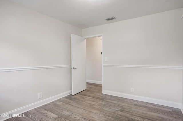 spare room featuring wood-type flooring