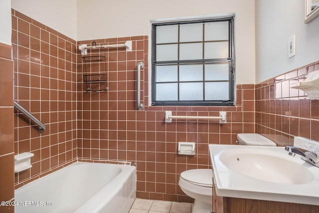 bathroom featuring tile patterned flooring, a bath, toilet, vanity, and tile walls