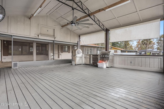 wooden terrace featuring an outdoor kitchen, ceiling fan, and area for grilling