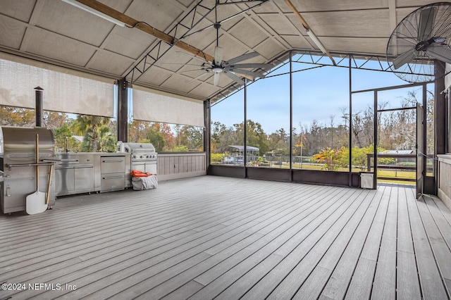 unfurnished sunroom featuring ceiling fan