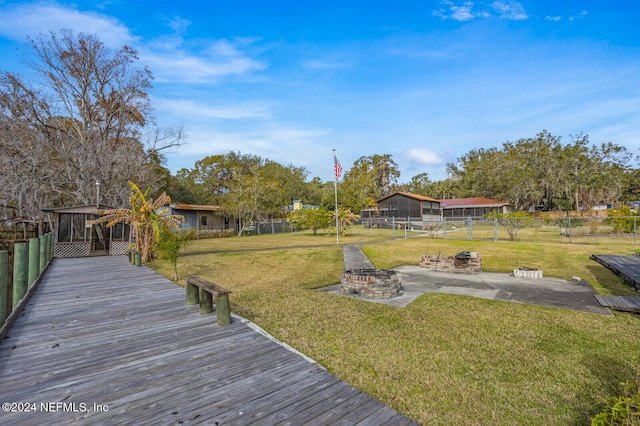 view of yard featuring an outdoor fire pit and a patio area