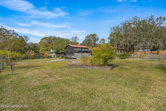 view of yard featuring a sunroom