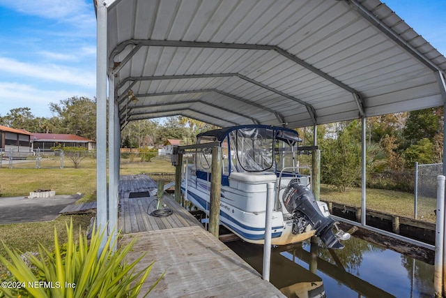 dock area featuring a lawn and a water view