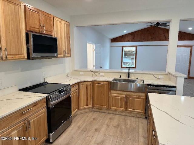 kitchen featuring stove, lofted ceiling, sink, ceiling fan, and light wood-type flooring