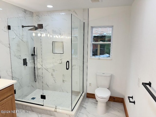 bathroom featuring vanity, toilet, and a shower with door