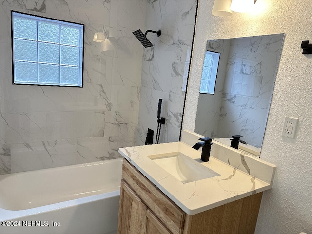 bathroom featuring vanity and tiled shower / bath combo