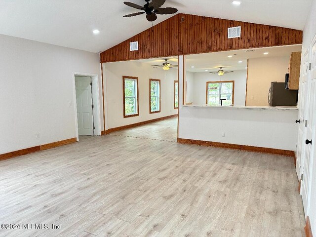 spare room featuring ceiling fan, light hardwood / wood-style flooring, and high vaulted ceiling