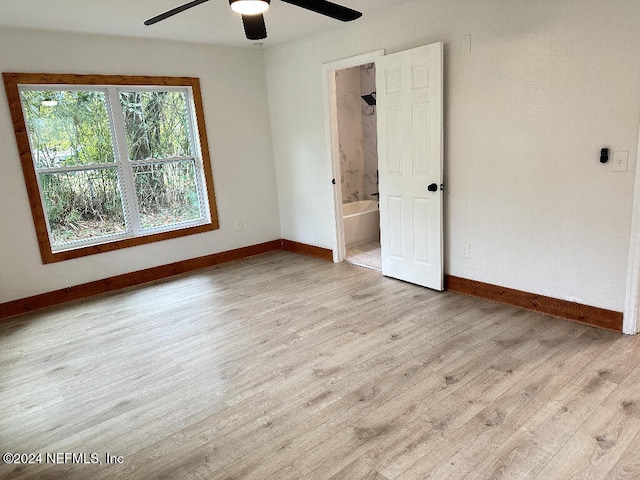 unfurnished room featuring light wood-type flooring and ceiling fan