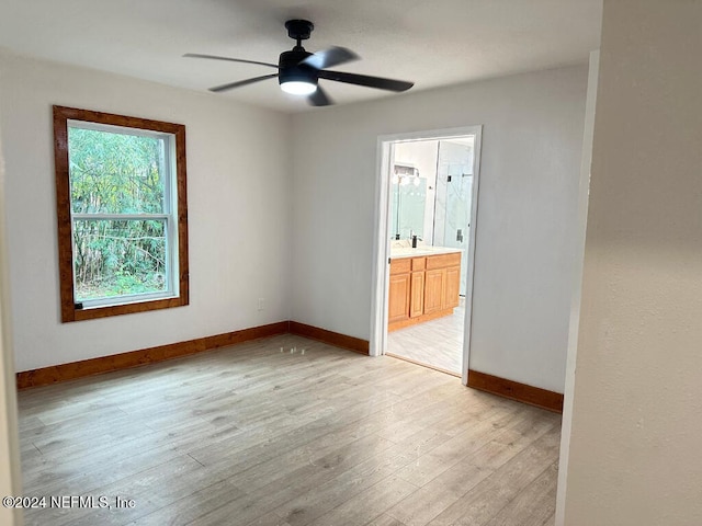 empty room featuring ceiling fan, light hardwood / wood-style floors, and sink