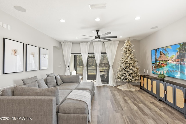 living room with ceiling fan and wood-type flooring