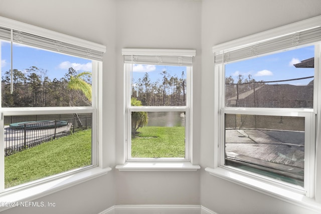 unfurnished sunroom featuring a water view