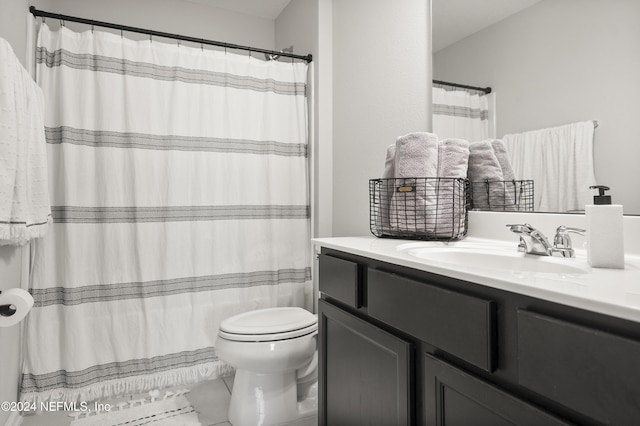 bathroom with tile patterned flooring, vanity, and toilet