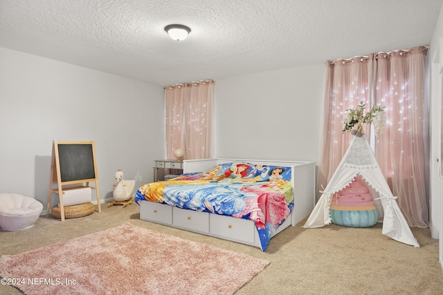 carpeted bedroom featuring a textured ceiling