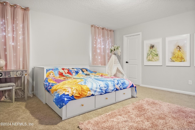 bedroom with carpet flooring and a textured ceiling