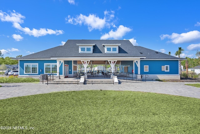 back of house with a patio area and a yard