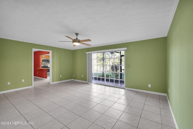 tiled spare room featuring ceiling fan and a textured ceiling