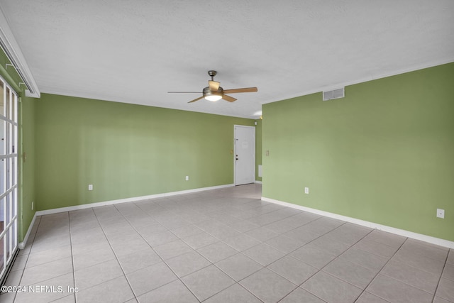 tiled spare room featuring ceiling fan and a textured ceiling