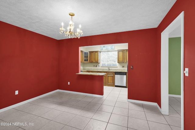 kitchen with dishwasher, an inviting chandelier, hanging light fixtures, light tile patterned flooring, and kitchen peninsula