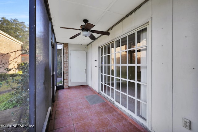 unfurnished sunroom with ceiling fan