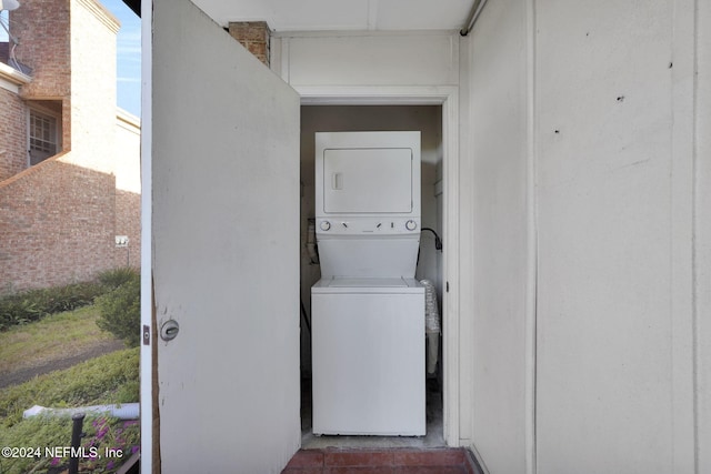 laundry room with stacked washer and clothes dryer