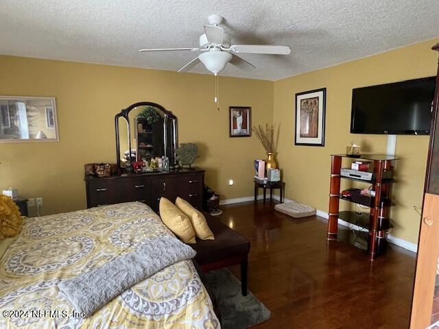 1837 The Glades Rd, Middleburg, FL 32068 - bedroom featuring a textured ceiling, wood finished floors, and a ceiling fan