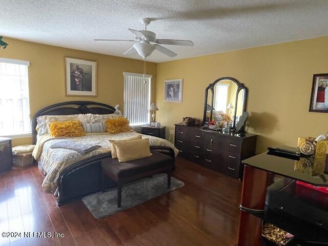 1837 The Glades Rd, Middleburg, FL 32068 - bedroom featuring dark wood-style flooring, a textured ceiling, and ceiling fan