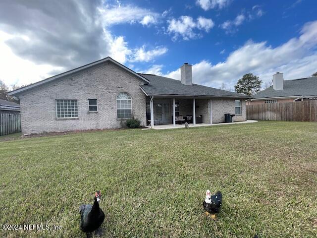 1837 The Glades Rd, Middleburg, FL 32068 - rear view of property with brick siding, a patio, and a chimney