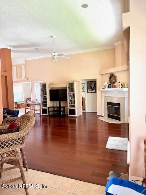 1837 The Glades Rd, Middleburg, FL 32068 - living area featuring ornamental molding, a ceiling fan, a fireplace, wood finished floors, and a textured ceiling