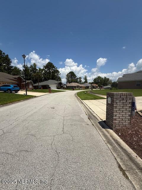 1837 The Glades Rd, Middleburg, FL 32068 - view of asphalt street with curbs and street lighting