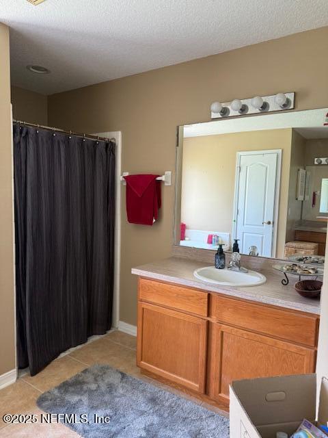 1837 The Glades Rd, Middleburg, FL 32068 - full bath featuring vanity, curtained shower, tile patterned floors, and a textured ceiling