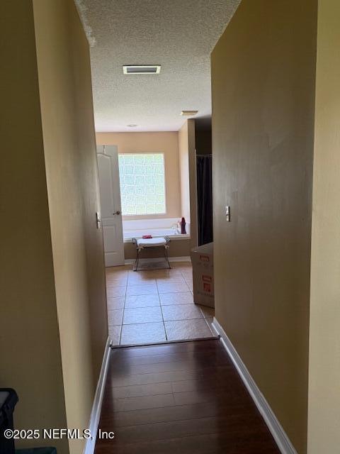 1837 The Glades Rd, Middleburg, FL 32068 - hallway with a textured ceiling and wood finished floors