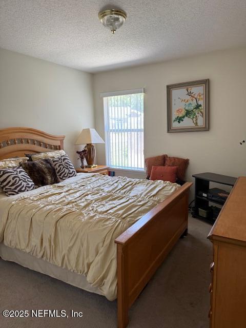 1837 The Glades Rd, Middleburg, FL 32068 - carpeted bedroom with a textured ceiling