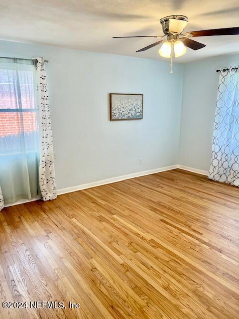 empty room featuring ceiling fan and light hardwood / wood-style flooring