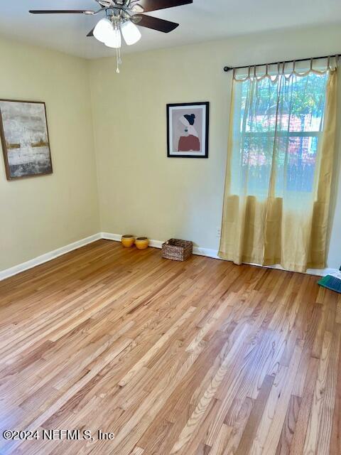 empty room featuring light hardwood / wood-style flooring and ceiling fan