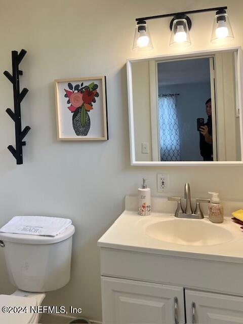 bathroom featuring vanity and toilet