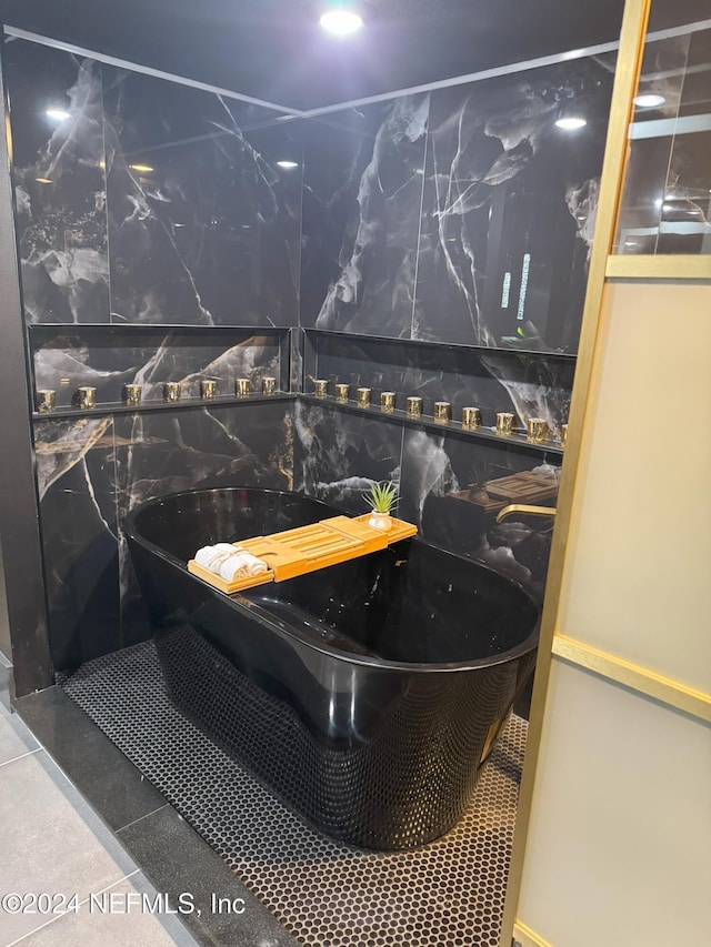 full bath with tile patterned flooring and a freestanding bath