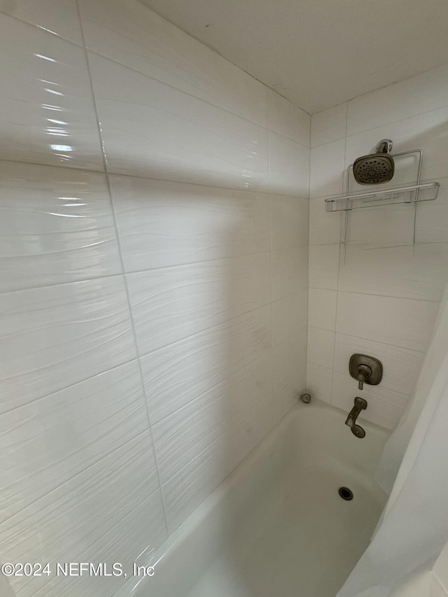 bathroom with shower / bath combination with curtain