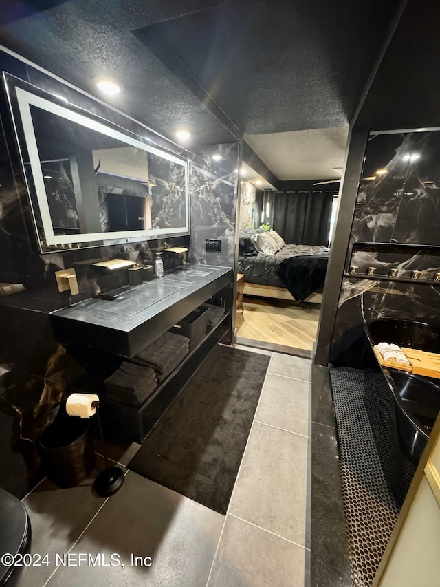 bathroom featuring tile patterned flooring and vanity